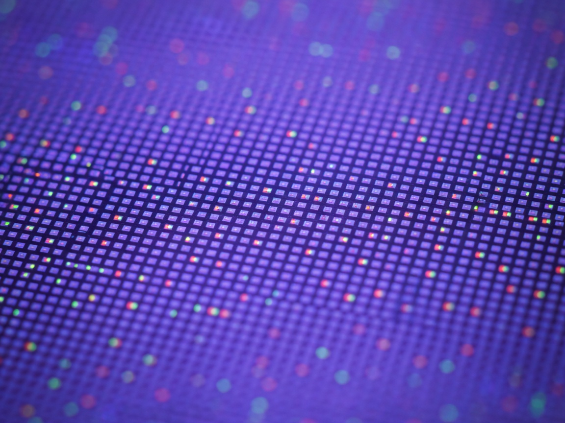 Shallow depth of field detail of an OLED screen pixel grid in purple light